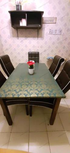 a table with a vase of flowers on top of it at AABM HOMESTAY Ipoh in Ipoh