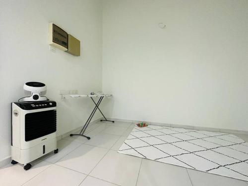 a white room with a stove and a white tile floor at Kluang 4 bedrooms 4 bathrooms in Kluang