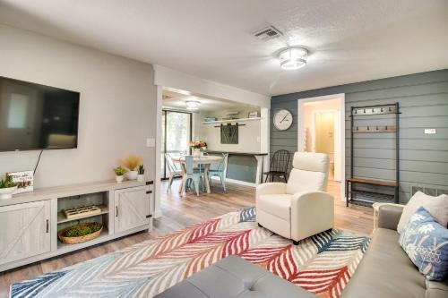 a living room with a couch and a tv at Deck and Dock Access Lakefront Grove Cabin! in Grove