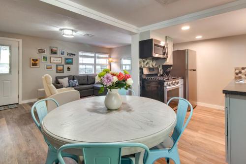 a kitchen and dining room with a table and chairs at Deck and Dock Access Lakefront Grove Cabin! in Grove