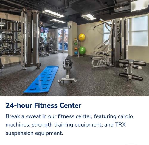 a gym with a fitness center with exercise equipment at Spacious 2 Bed, 2 Bath Uptown Gem in the Heart of the City-Parking-Wi-Fi-Balcony-Walk to BOA Stadium in Charlotte