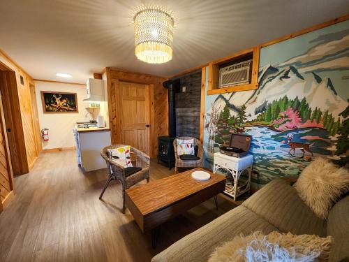 a living room with a couch and a table at Belleayre Lodge in Pine Hill