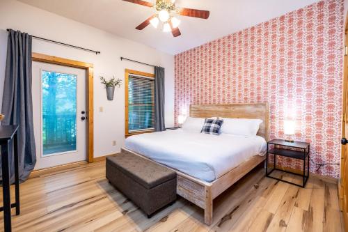 a bedroom with a bed and a window at SmokiesBoutiqueCabins would love to host you! 4 miles to Gatlinburg Strip! Resort Pool open May 1 through Oct 1! Views, Shuffleboard, Hot Tub, Arcade! in Gatlinburg