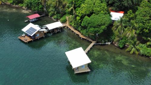 an aerial view of a house in the water at Ponci’s Gate to Gaia Holistic Center in Bocas del Toro