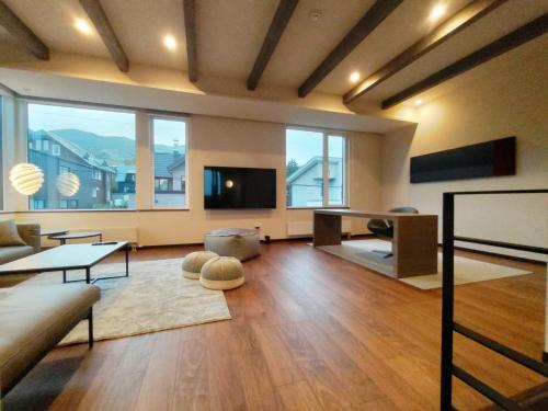 a large living room with a couch and a tv at Apres in Furano