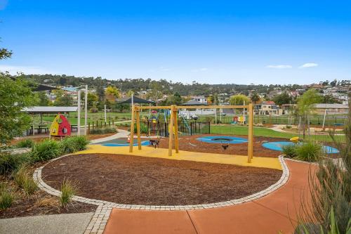 a park with a playground with slides and swings at Rose Bay Riverfront - Dreamy Luxury by the Water in Montagu Bay