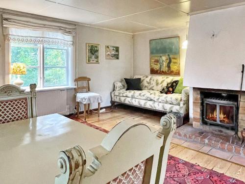 a living room with a couch and a fireplace at 6 person holiday home in LOFTAHAMMAR-By Traum in Loftahammar