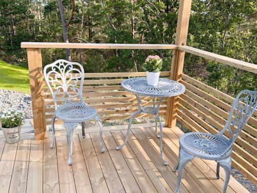 two chairs and a table and two chairs on a deck at 4 star holiday home in Frillesås-By Traum in Frillesås