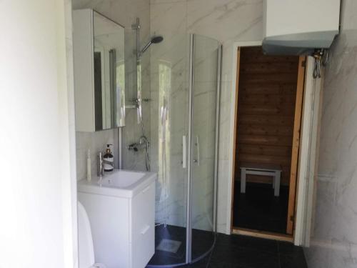a bathroom with a shower and a toilet and a sink at Holiday home Skutskär in Älvkarleby