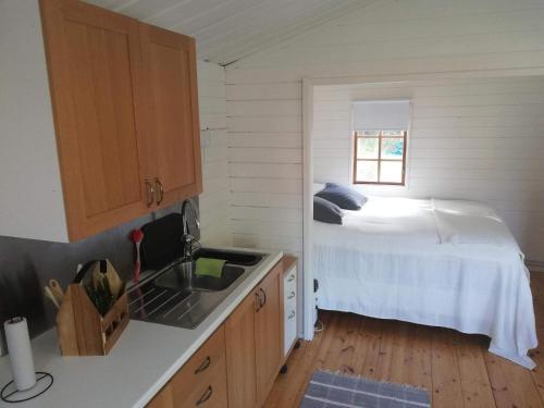 a kitchen with a bed in the corner of a room at 4 star holiday home in Skutskär-By Traum in Älvkarleby