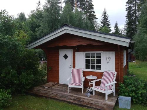 a small shed with two chairs and a table at 4 star holiday home in Skutskär-By Traum in Älvkarleby