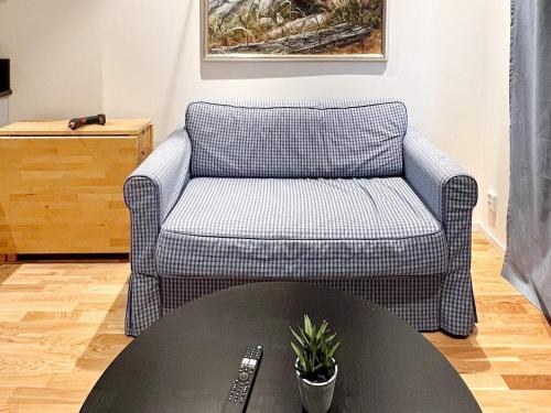 a living room with a chair and a table at 5 person holiday home in MUNSö-By Traum in Solsidan