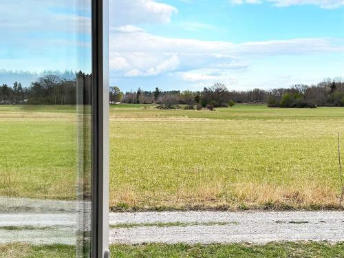 a view of a field from a window at 5 person holiday home in MUNSö-By Traum in Solsidan