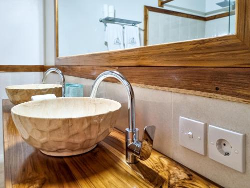 La salle de bains est pourvue d'un lavabo et d'un miroir. dans l'établissement Komodo Resort, à Sebayur