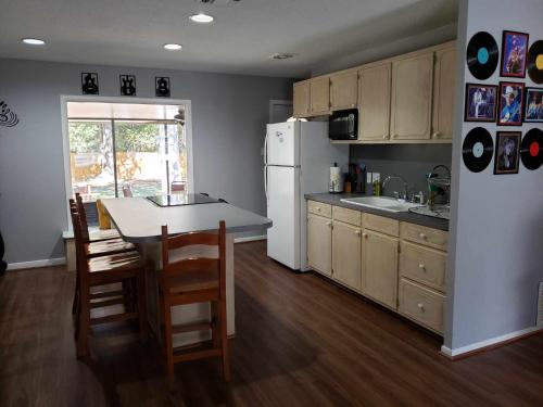 a kitchen with a table and a white refrigerator at Midtown Southern Charm in Tyler