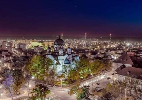a view of a city at night with a building at Blue light ultracentral in Craiova