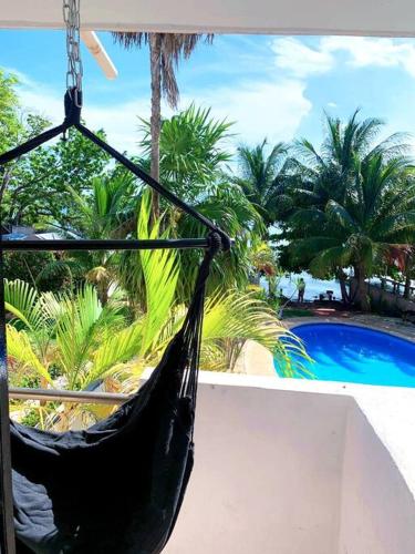 a black hammock hanging in front of a pool at Villa Laguna Cancún, kayaks gratis. in Cancún