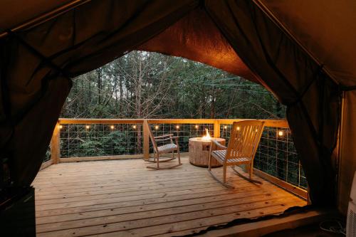 a gazebo with a table and chairs on a deck at Treehouse Cozy Glamping Site in Branson