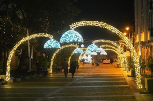 a group of archways with lights on a street at night at Sweet cozy Ultracentral in Craiova