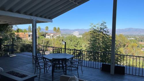 a patio with chairs and a table on a deck at VIEW PRIVATE FEMALE Short-Long Term Day-Week-Month Un-Furnished Home-House-Estate Bedrooms-Studio-ADU-Guesthouse-Vacation Rental Encino Hills 405-101 xSepulveda in Encino