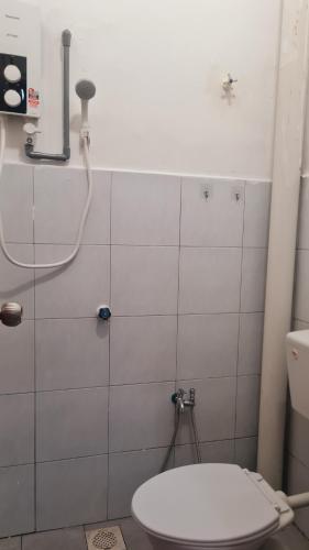 a bathroom with a toilet and a shower at Anjung KLIA House 01 With Neflix & Airport Shuttle in Banting