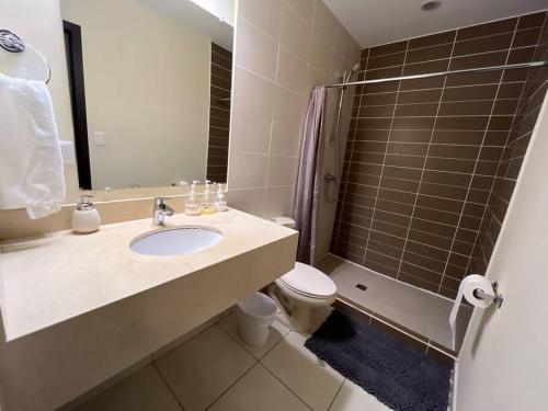 a bathroom with a sink and a toilet and a shower at Business Stay 2-BR Apartment in Centro Morazán in Tegucigalpa