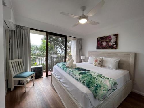 a bedroom with a large bed and a window at Royal Palm Resort on the Beach in Gold Coast