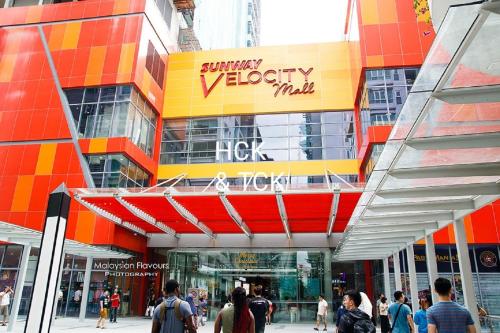 a group of people walking in front of a building at Next2Mall at Sunway Velocity Two by HCK in Kuala Lumpur