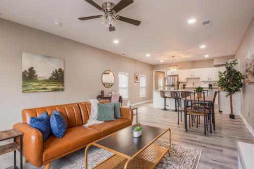 a living room with a couch and a table at Newly renovated 4BR CozySuites in Louisville