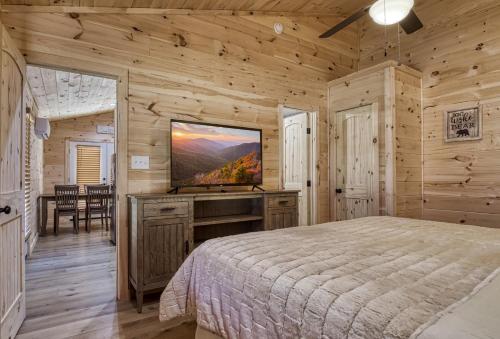 A bed or beds in a room at Jolly Jingle Cabin, Pickleball Court, Creek, WIFI, Mountain Views, Starting at 79"