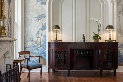 a room with a wooden cabinet with wine bottles at Hamilton Turner Inn in Savannah