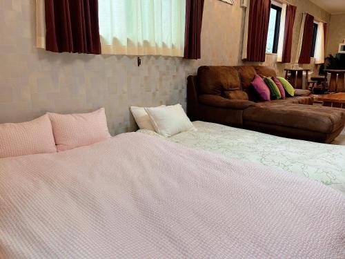 a bedroom with a bed and a couch at CuteFamilyHouse! 8min Shinjuku 5minJR 3minSubway Cozy,Quiet KidsFree Under6yrs in Tokyo