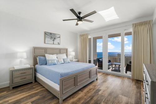 a bedroom with a bed and a balcony with the ocean at Luxurious 4 Bedroom Condo! Gulf Views! Sleeps 10 & Easy Beach Access! by Dolce Vita Getaways PCB in Panama City Beach