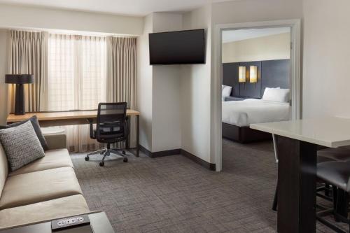 a hotel room with a bed and a desk at Residence Inn Providence Coventry in Spring Lake