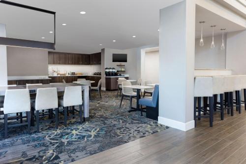 a dining room and kitchen with tables and chairs at Residence Inn Providence Coventry in West Greenwich