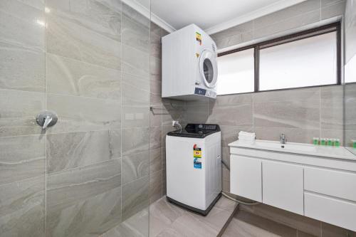 uma casa de banho com um frigorífico e um lavatório em Econo Lodge Lilydale em Lilydale
