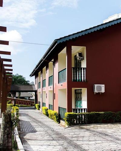 a red and white building with balconies on a street at Spazio Vital Apartments in Florianópolis