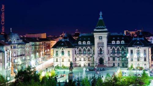 a view of a large building at night at Black&White Studio Ultracentral in Craiova