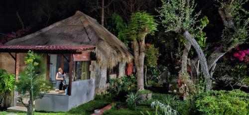 a model of a house with a woman standing outside at Villa Anjing in Nusa Dua