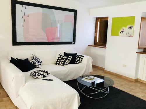 a living room with two white couches and a table at Dieci7 in Montefiascone