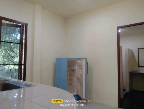 a kitchen with a counter and a blue refrigerator at 2 one bedroom houses 400 meters from the deach in Amphoe Koksamui