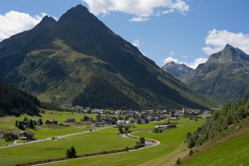 a village in a valley with mountains in the background at Hotel Zontaja Superior in Galtür