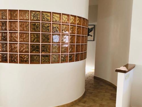 a wall with a bunch of glass squares on it at Dieci7 in Montefiascone