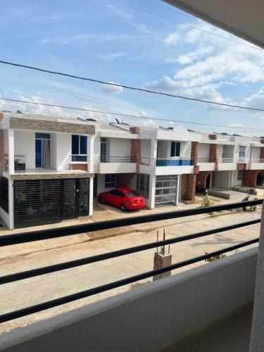 a red car parked in front of a building at Habitación confortable in Valledupar