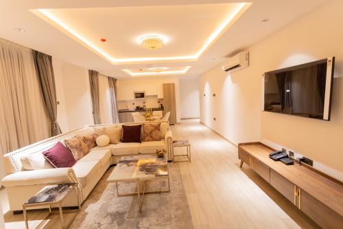 a living room with a couch and a tv at Veronique Heights in Kumasi