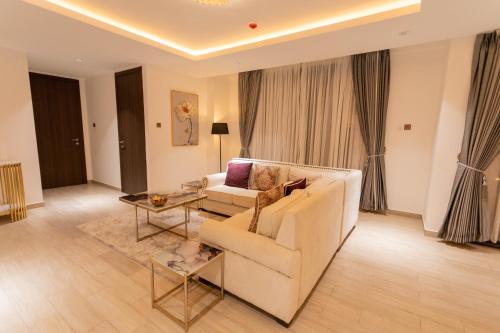 a living room with a white couch and a table at Veronique Heights in Kumasi
