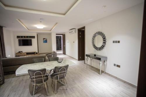 a living room with a table and a couch at Veronique Heights in Kumasi