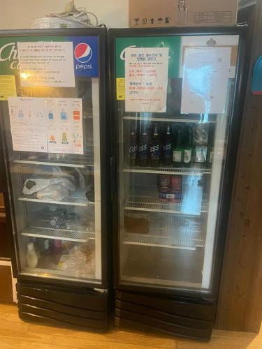 two refrigerators are standing next to each other at Hanra guesthouse in Jeju