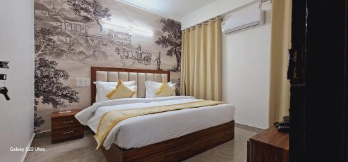 a bedroom with a large bed and a wall mural at The Grand ND Resort- Kanha Tulsi Heights Behind Prem Mandir in Vrindāvan