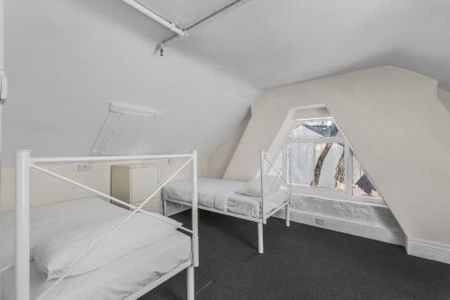 a room with two bunk beds and a window at Lillou Hostels in Sydney